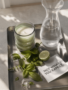 Mint & basil scented candle in green glass jar with white wick, labeled OBJECT 04.