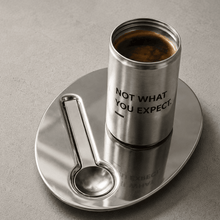 Stainless steel candle holder with engraved text and amber wax in glass jar