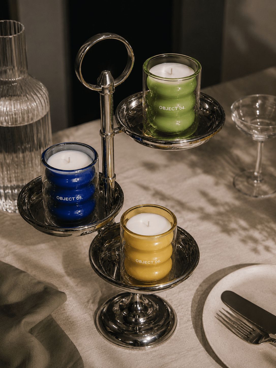 Mint & basil scented candle in green glass jar with white wick on stand, labeled OBJECT 04.